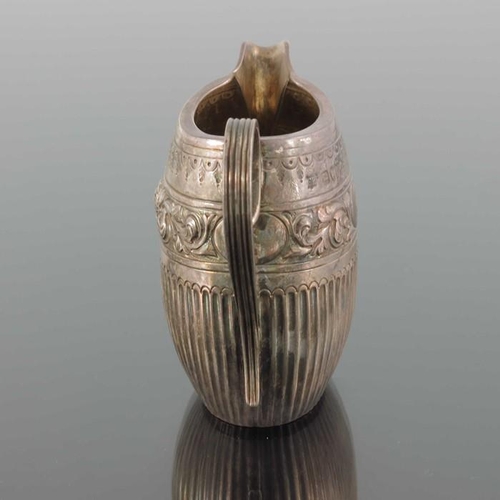 74 - A Victorian silver jug, William Hutton, London 1884, oval barrel form, half fluted below  band of em... 