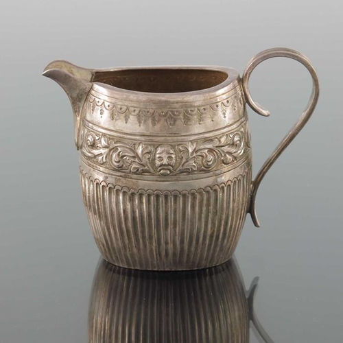 74 - A Victorian silver jug, William Hutton, London 1884, oval barrel form, half fluted below  band of em... 