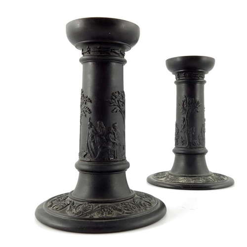 900 - A pair of Wedgwood black basalt candlesticks, early 19th century, Tuscan column form, decorated with... 