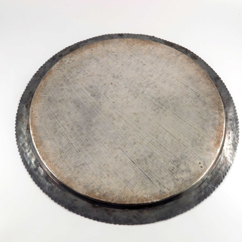 1 - A large Indian white metal tray, circular form, chased and engraved with various figures within a fo... 