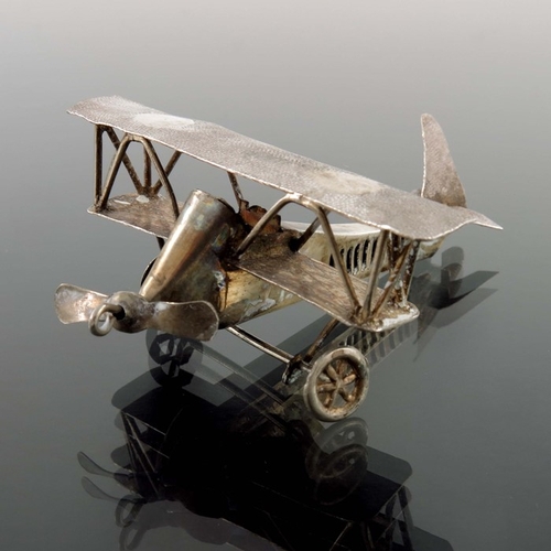 10 - A pair of novelty white metal aeroplanes, sheet and wire construction with movable wheels and propel... 