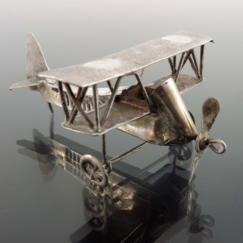 10 - A pair of novelty white metal aeroplanes, sheet and wire construction with movable wheels and propel... 