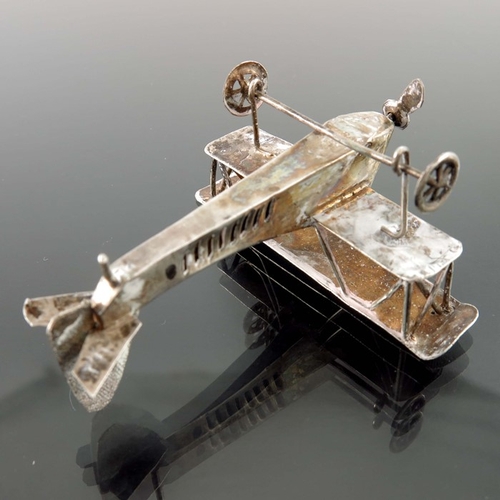 10 - A pair of novelty white metal aeroplanes, sheet and wire construction with movable wheels and propel... 