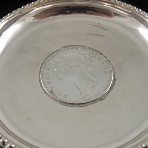 13 - Three Indian silver coin dishes, two set with Victoria Rupees, one embossed with a simulated Persian... 