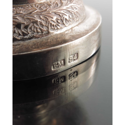 17 - A Chinese export silver goblet, TM, rounded beaker form with stepped foot, repousse embossed in the ... 