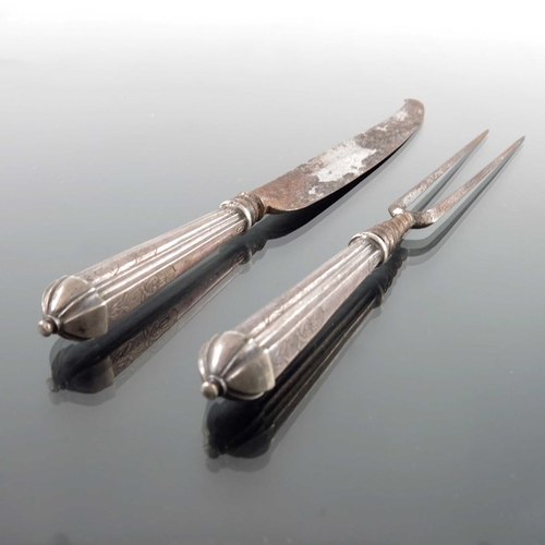 46 - A German silver handled knife and fork, IG, Nuremberg circa 1750, fluted and chased handles, with kn... 