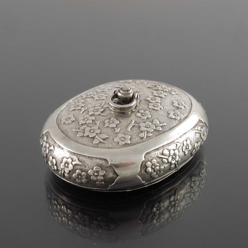 5 - A Chinese silver snuff box, 19th century, oval form, engraved and chased with prunus within ogee car... 