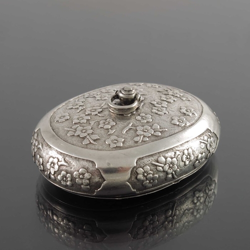 5 - A Chinese silver snuff box, 19th century, oval form, engraved and chased with prunus within ogee car... 