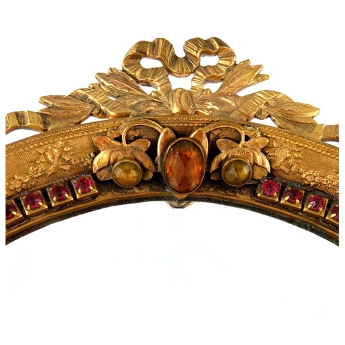 337 - A 19th century French gilt brass and paste set mirror, bevelled oval form, tooled and chased with ri... 
