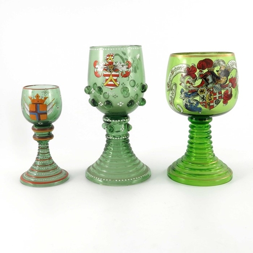457 - Three Bohemian enamelled historicist glass roemers, each with a heraldic coat of arms, ribbed stems,... 