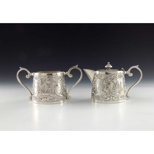15 - A Chinese Persian style white metal teapot and sugar bowl, oval conical form, repousse embossed and ... 