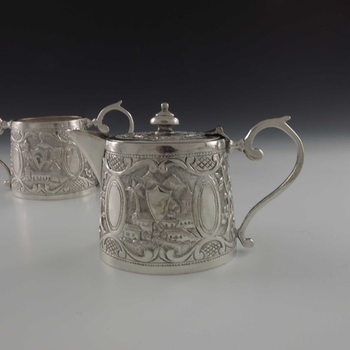15 - A Chinese Persian style white metal teapot and sugar bowl, oval conical form, repousse embossed and ... 