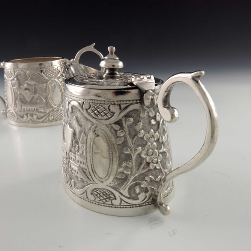 15 - A Chinese Persian style white metal teapot and sugar bowl, oval conical form, repousse embossed and ... 