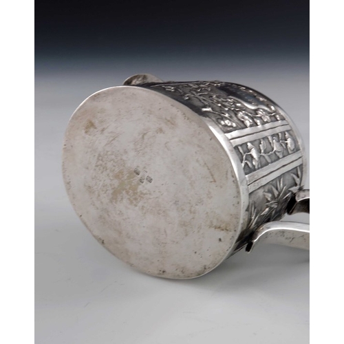 7 - A Chinese export silver jug, circa 1890, conical oval form, repousse embossed with panels of prunus ... 