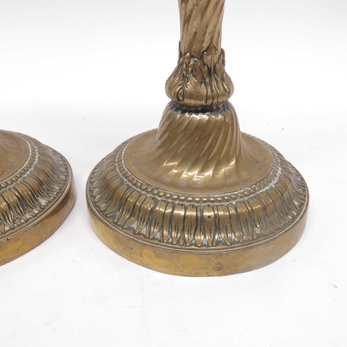 115 - A pair of early 19th Century brass candlesticks, baluster column on wrythen circular foot with acant... 