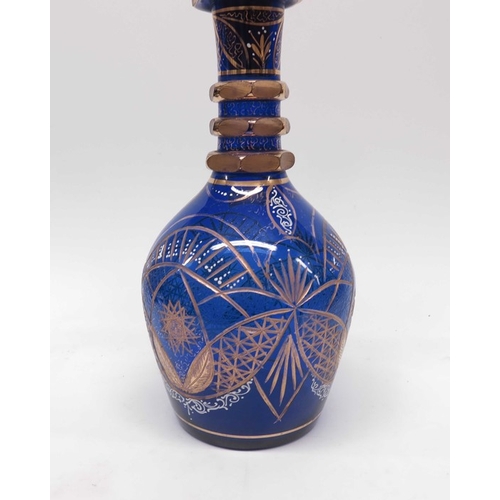 26 - A large Bohemian blue glass decanter and stopper,  baluster form, triple ringed neck with Persian st... 