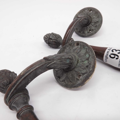 93 - A pair of bronze door handles, circa 1890, double baluster from with pineapple finials and floral mo... 