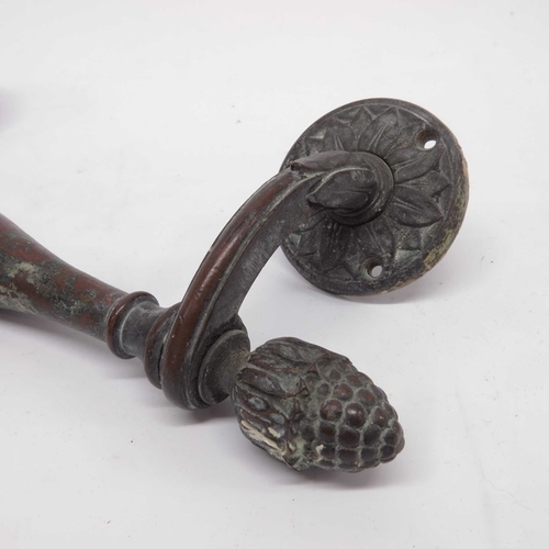 93 - A pair of bronze door handles, circa 1890, double baluster from with pineapple finials and floral mo... 