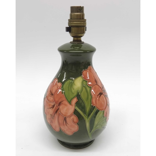 916 - Walter Moorcroft, Hibiscus on green lamp base, baluster form, impressed marks, 22cm high