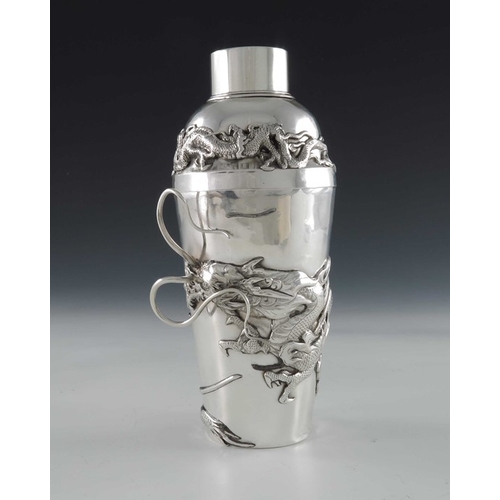 10 - A Chinese silver cocktail shaker, circa 1920, the body applied with a cast dragon in relief amongst ... 