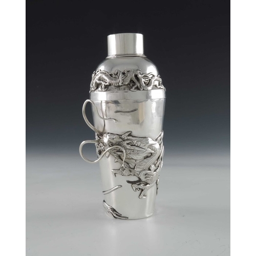 10 - A Chinese silver cocktail shaker, circa 1920, the body applied with a cast dragon in relief amongst ... 