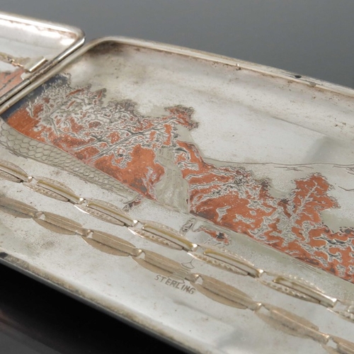 3 - A Japanese silver and mixed metal cigarette case, circa 1930s, incised with a landscape of mountains... 