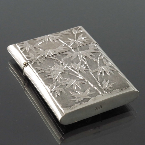 5 - A Chinese silver card case, circa 1900, embossed in relief with a dragon amongst clouds, the reverse... 