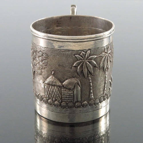 8 - An Indian white metal mug, late 19th century, cylindrical form, repousse embossed and chased with tr... 