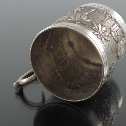 8 - An Indian white metal mug, late 19th century, cylindrical form, repousse embossed and chased with tr... 