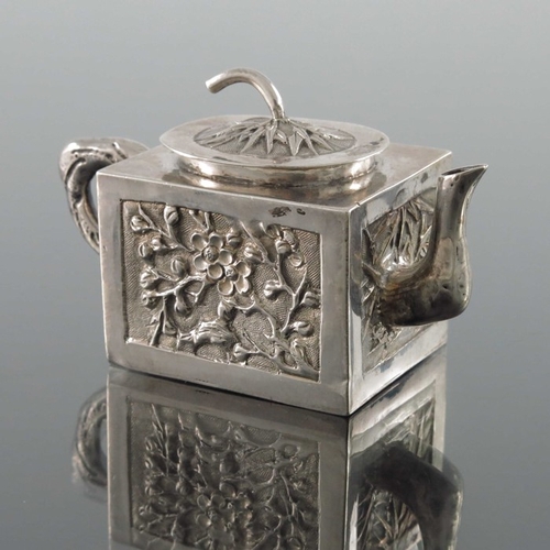 11 - A Chinese export miniature silver teapot, Wing Fat, circa 1900, cuboid form, embossed and chased wit... 