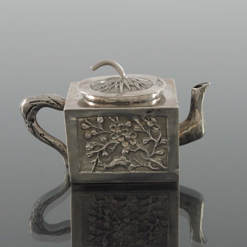 11 - A Chinese export miniature silver teapot, Wing Fat, circa 1900, cuboid form, embossed and chased wit... 