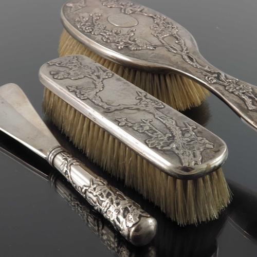 13 - A Chinese silver three piece brush and shoe horn set, Tuck Chang, Shanghai circa 1910, embossed with... 