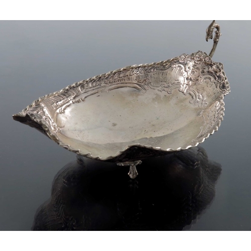 25 - A Continental silver dish, shallow lobed form, embossed with Rococo scrolls and feathered shell bord... 