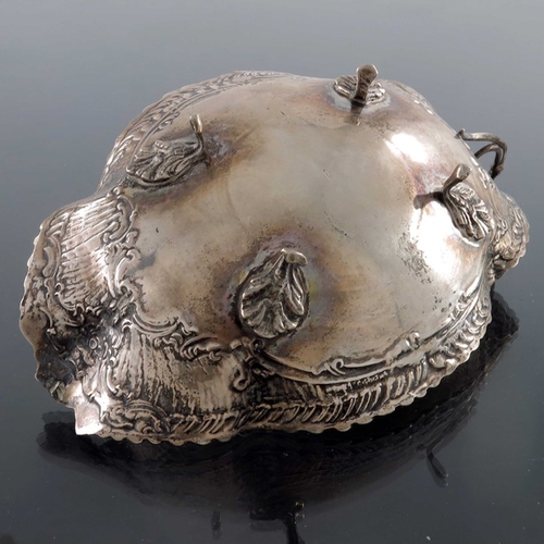 25 - A Continental silver dish, shallow lobed form, embossed with Rococo scrolls and feathered shell bord... 