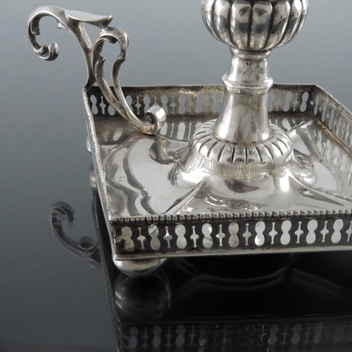 27 - A Portuguese silver chamberstick, Porto 19th Century, of Neoclassical form, lozenge form with reticu... 