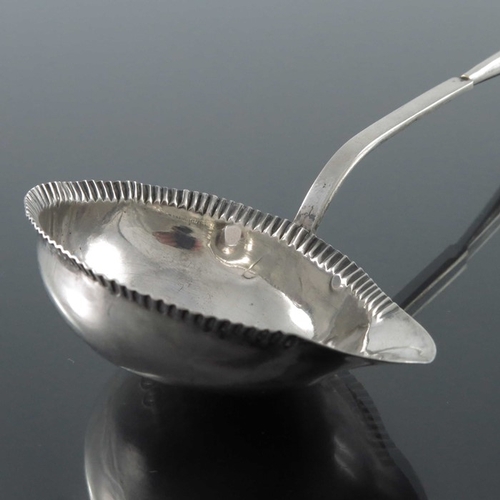 38 - A French silver and horn ladle, Paris circa 1797, the boat shaped bowl with stamped gadrooning to th... 