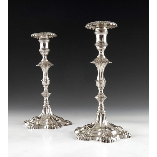 42 - A pair of cast Continental silver candlesticks, 18th century, the stepped petal bases with moulded f... 