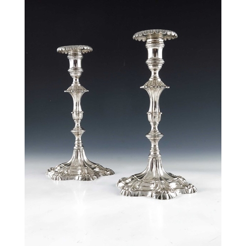 42 - A pair of cast Continental silver candlesticks, 18th century, the stepped petal bases with moulded f... 