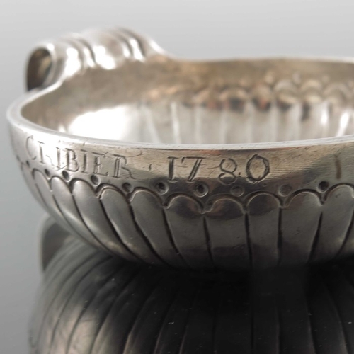 43 - A Louis XV French silver wine taster, IF, Orleans 1774,  the incised reeded body with beaded border,... 