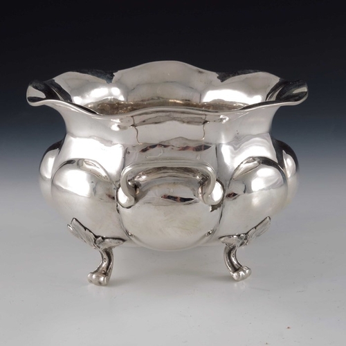 47 - An Imperial Russian silver bowl, St Petersburg 1873, twin handled, lobed squat baluster form, on fou... 