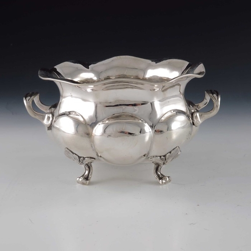 47 - An Imperial Russian silver bowl, St Petersburg 1873, twin handled, lobed squat baluster form, on fou... 