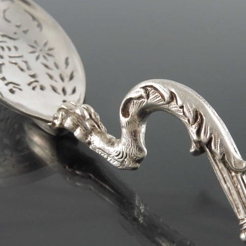 58 - A Dutch silver sifter spoon, the pierced bowl on a cast zoomorphic foliate griffin stem, 14cm long, ... 