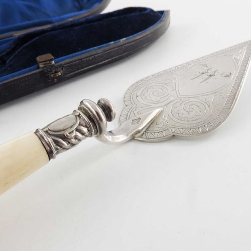 102 - A Victorian silver plated and carved ivory handled butter trowel, circa 1880, the blade engraved wit... 