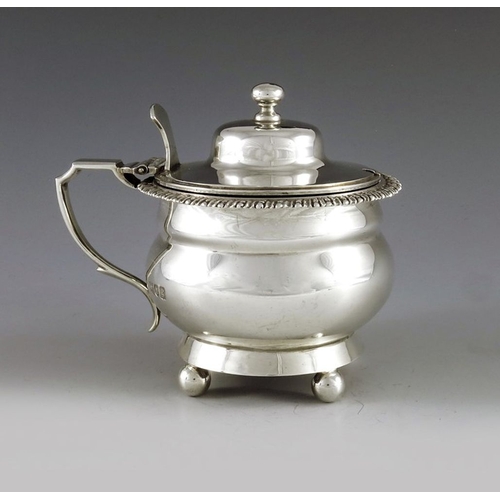 106 - Charles Stuart Harris, London 1902, an Edwardian silver mustard pot, double ogee ovoid form, on four... 