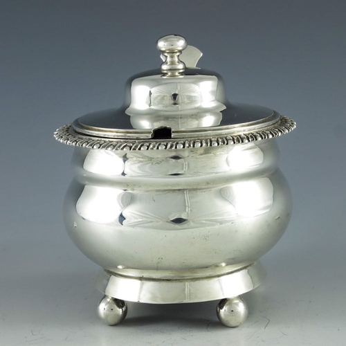 106 - Charles Stuart Harris, London 1902, an Edwardian silver mustard pot, double ogee ovoid form, on four... 