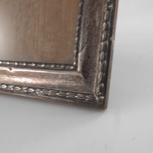 142 - A George V silver photo frame, W I Broadway and Co., Birmingham 1919, rectangular with relief moulde... 