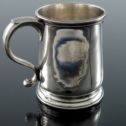 145 - A George II silver mug, Richard Burcombe, London 1731, plain cylindrical baluster form, on stepped o... 