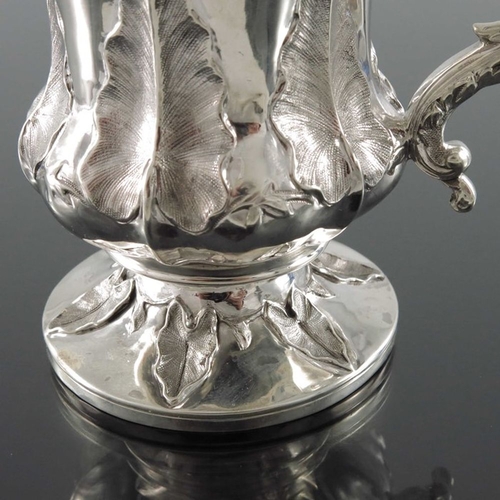 164 - A William IV silver mug, Charles Fox, London 1831, footed Campana form, embossed and chased with lea... 