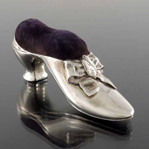 166 - A Victorian silver novelty pin cushion, Birmingham 1890, in the form of a shoe, with ribbon bow, pur... 