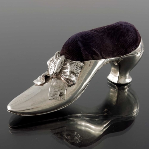 166 - A Victorian silver novelty pin cushion, Birmingham 1890, in the form of a shoe, with ribbon bow, pur... 